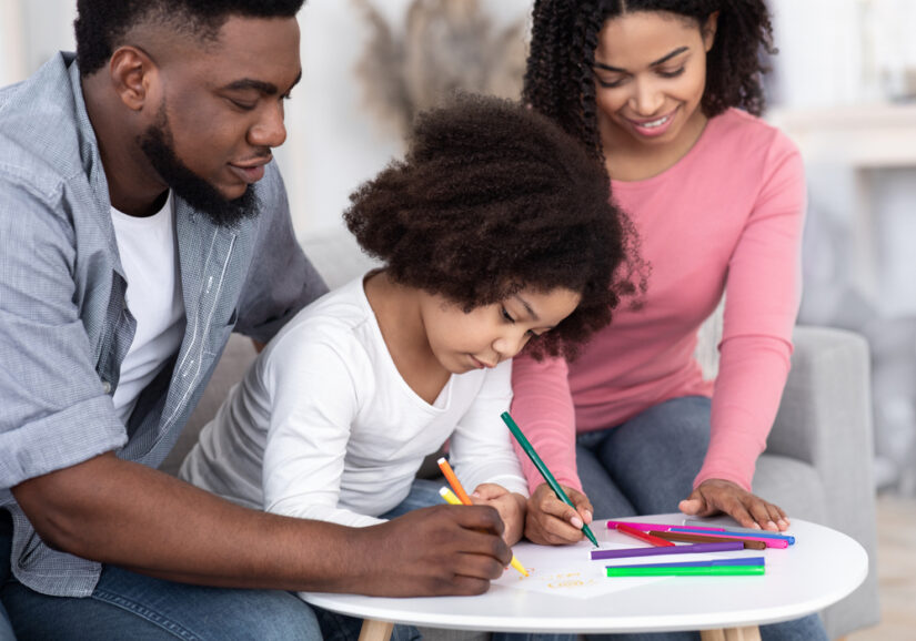 Photo of Parents Teaching Drawing to Their Child