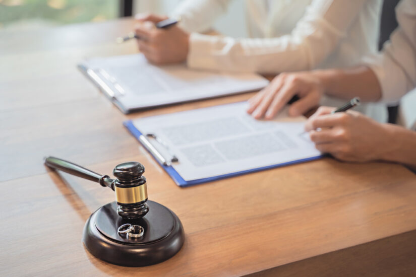 Photo of a Couple Signing Agreement